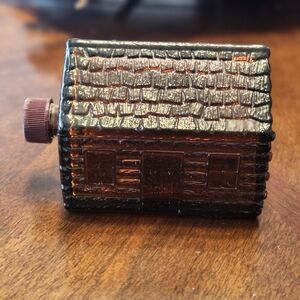 vintage Avon Wild Country aftershave bottle in the shape of a log cabin. 